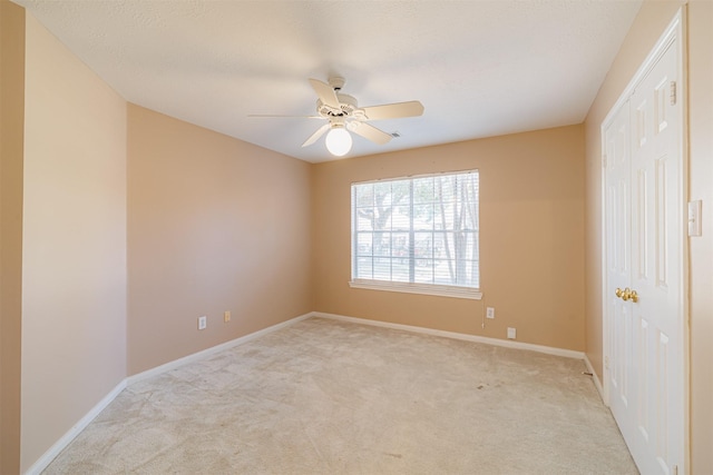 carpeted empty room with ceiling fan