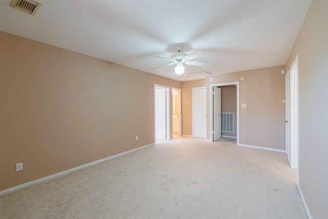 unfurnished room featuring light colored carpet and ceiling fan