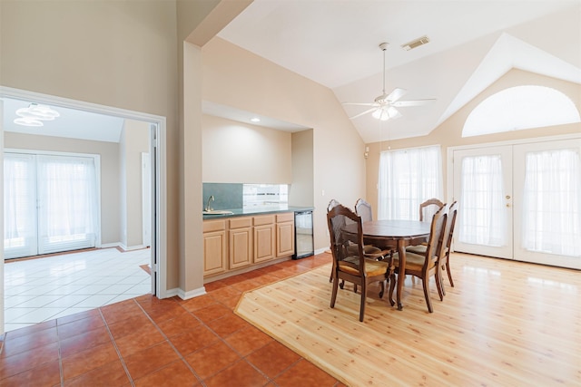 dining room with vaulted ceiling, sink, tile patterned flooring, ceiling fan, and french doors