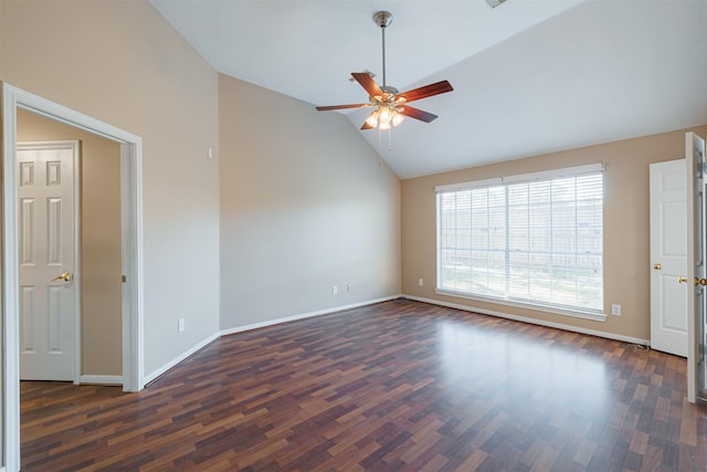 empty room with lofted ceiling, dark hardwood / wood-style floors, and ceiling fan