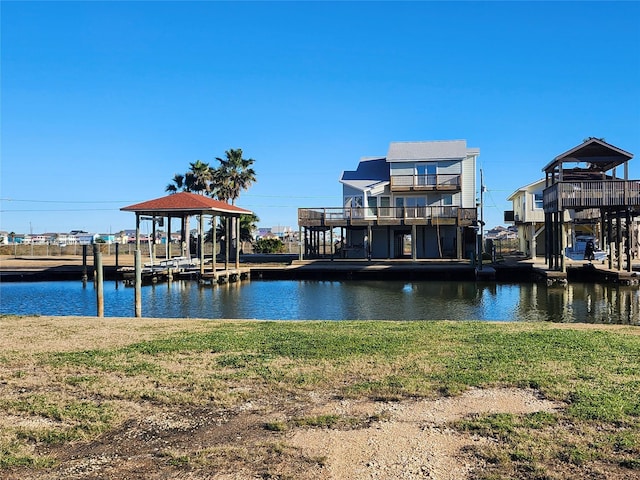 dock area with a lawn and a water view