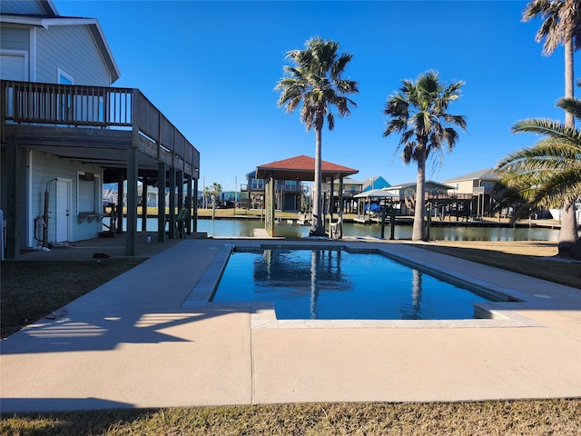 view of swimming pool featuring a water view