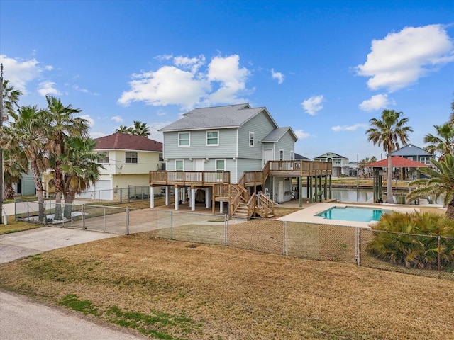 view of swimming pool featuring a wooden deck, a yard, and a patio