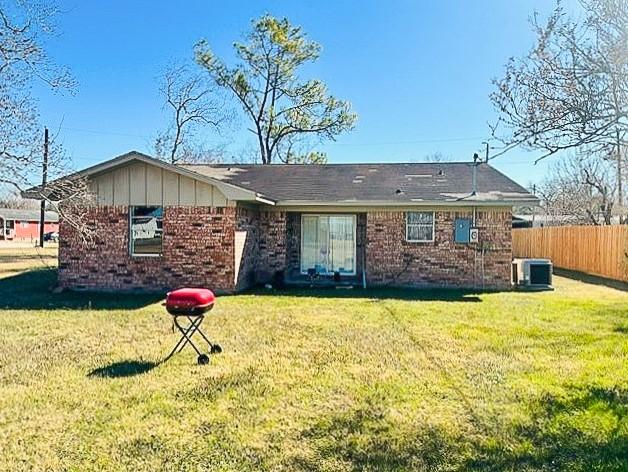 view of front facade with central AC unit and a front lawn