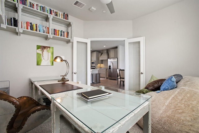 home office with hardwood / wood-style flooring and ceiling fan