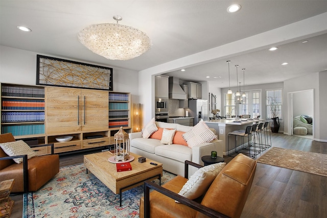 living room with an inviting chandelier and wood-type flooring