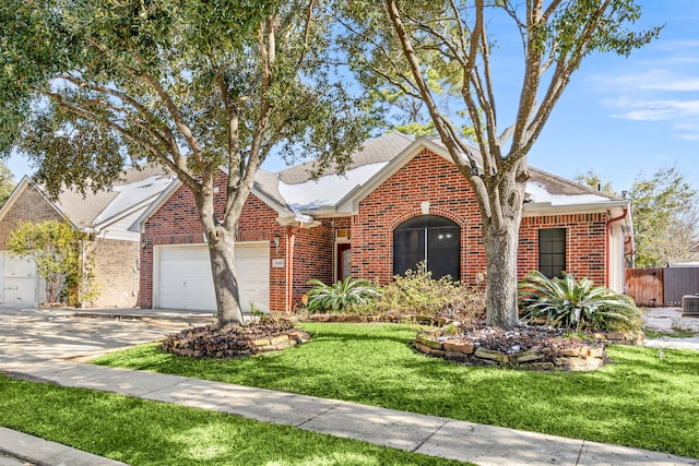 view of front of house with a garage and a front lawn