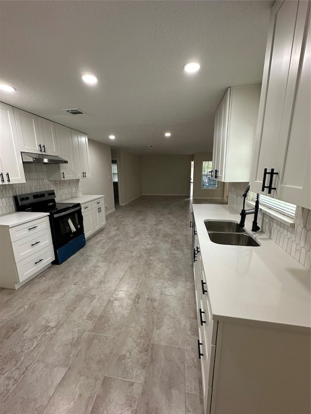 kitchen featuring white cabinetry, black range with electric stovetop, sink, and decorative backsplash