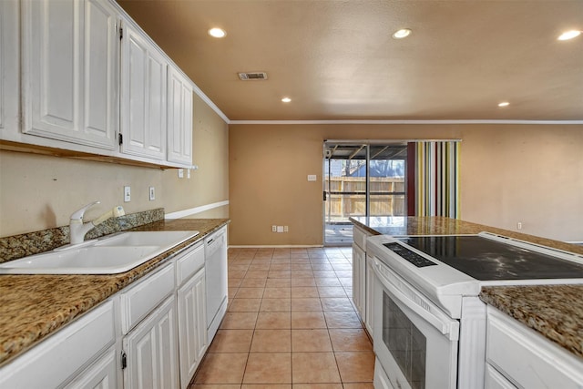 kitchen with sink, white appliances, crown molding, white cabinetry, and light tile patterned flooring