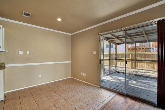 tiled spare room featuring crown molding