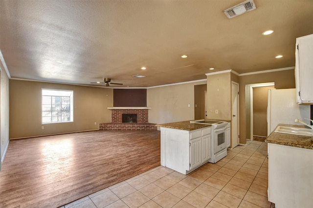 kitchen with sink, white appliances, ceiling fan, white cabinetry, and light tile patterned flooring