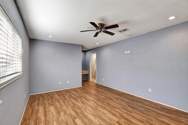 unfurnished room featuring ceiling fan and light wood-type flooring