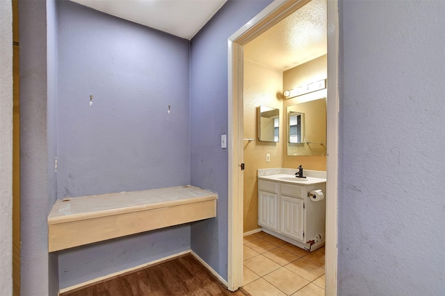 bathroom featuring vanity, tile patterned floors, and a textured ceiling