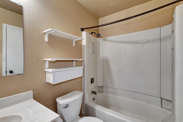 full bathroom featuring vanity, a textured ceiling, shower / bathtub combination, and toilet