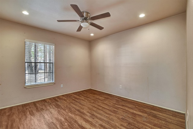 unfurnished room with hardwood / wood-style flooring and ceiling fan