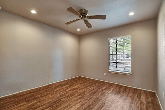 empty room with hardwood / wood-style flooring and ceiling fan