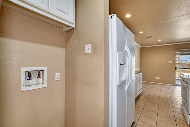 kitchen with white cabinetry, crown molding, light tile patterned floors, and white appliances