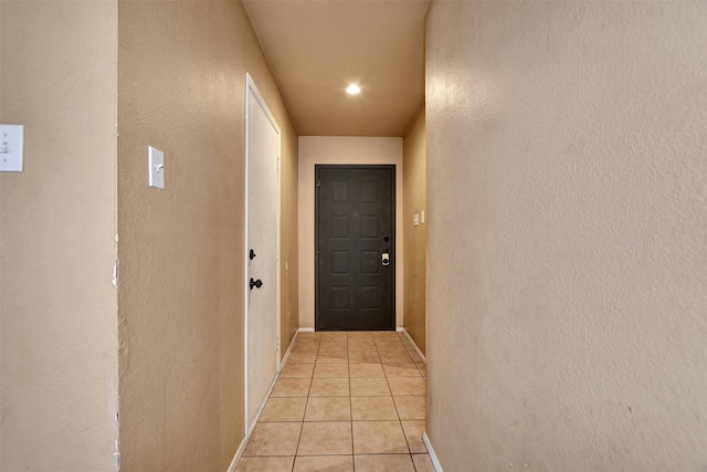 doorway to outside with light tile patterned floors