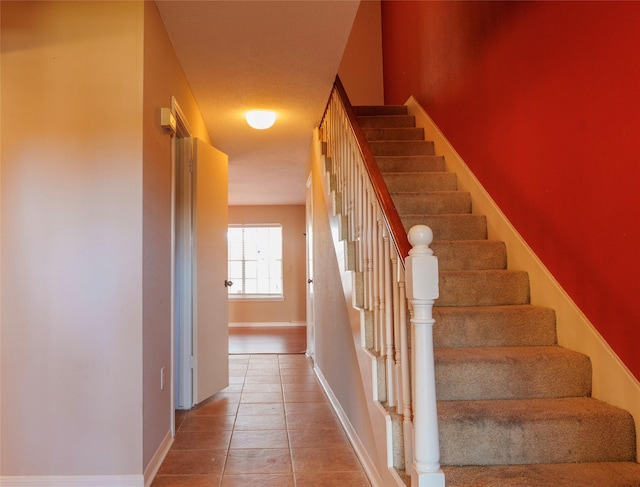 stairs featuring tile patterned floors