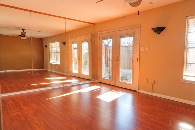 interior space featuring french doors, ceiling fan, a healthy amount of sunlight, and hardwood / wood-style flooring