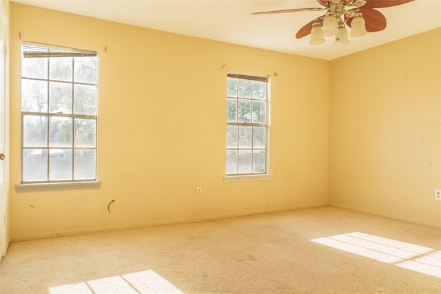 carpeted spare room with ceiling fan