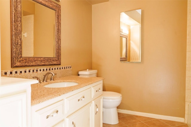 bathroom featuring tile patterned flooring, vanity, and toilet