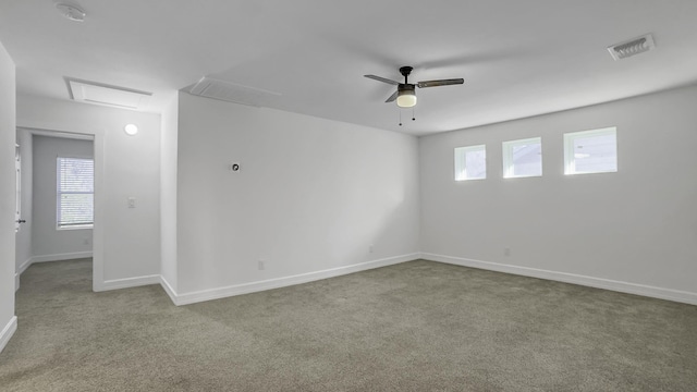 carpeted empty room featuring ceiling fan