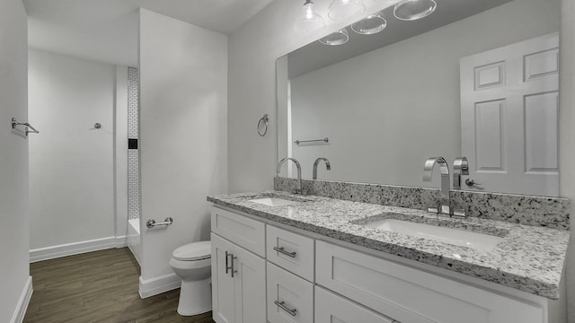 bathroom featuring hardwood / wood-style flooring, vanity, and toilet