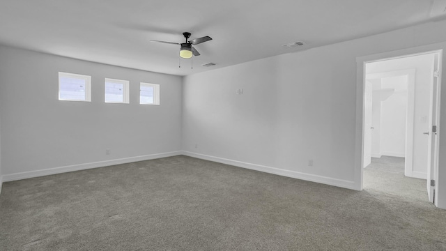 carpeted spare room with ceiling fan