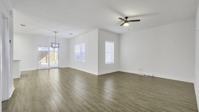 unfurnished living room with ceiling fan and dark hardwood / wood-style floors