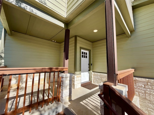 view of exterior entry featuring covered porch