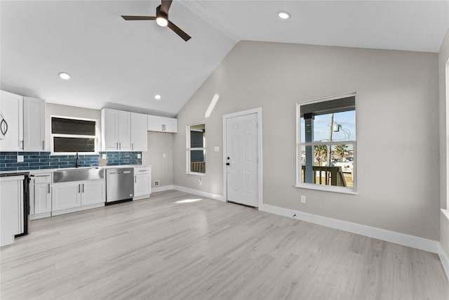 kitchen featuring sink, light hardwood / wood-style flooring, dishwasher, backsplash, and white cabinets