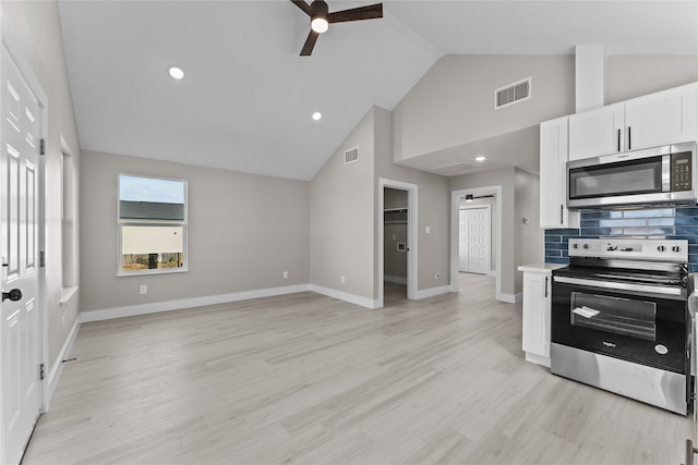 kitchen with light wood-type flooring, backsplash, ceiling fan, stainless steel appliances, and white cabinets