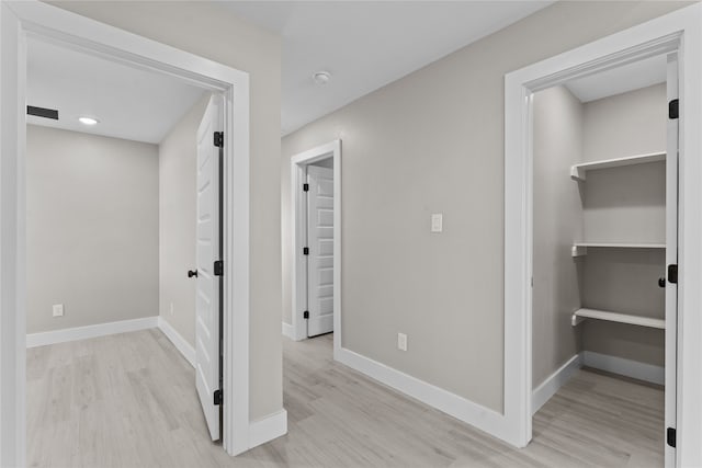 hallway with light hardwood / wood-style flooring