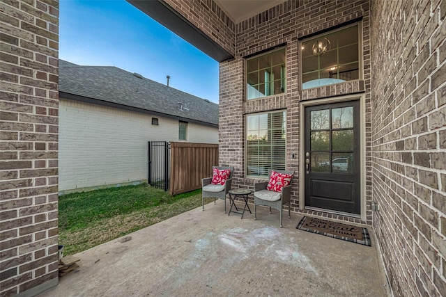 view of exterior entry featuring a patio area