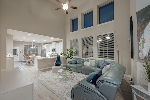 living room featuring light hardwood / wood-style floors and ceiling fan