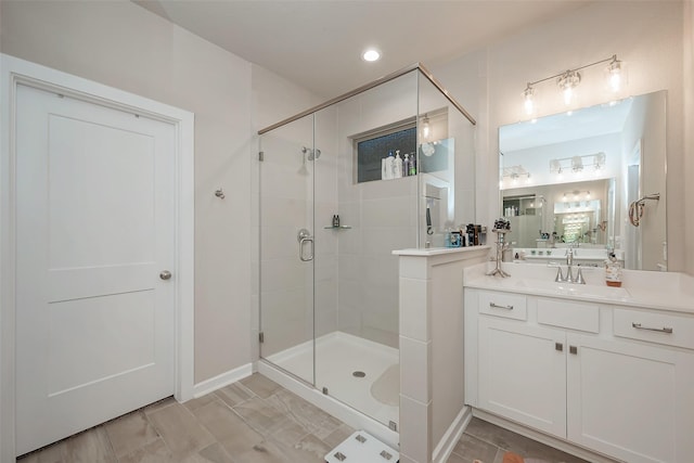 bathroom featuring an enclosed shower and vanity