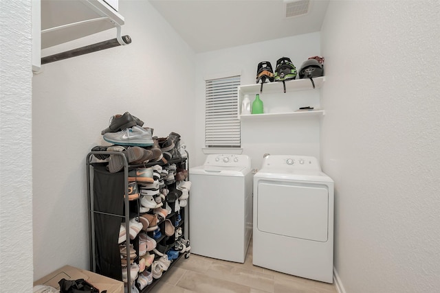 laundry room featuring washing machine and clothes dryer