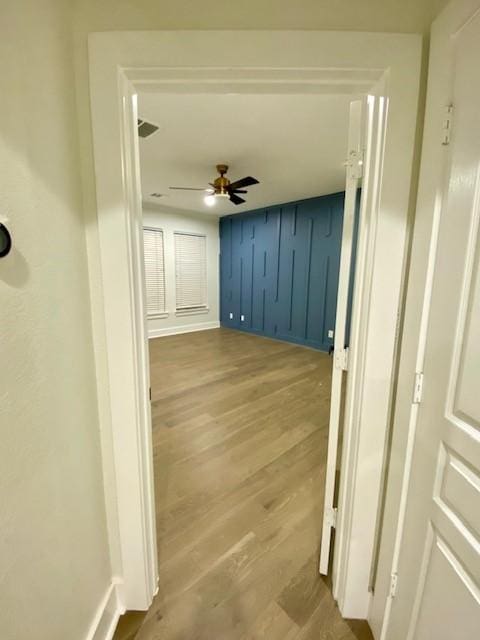 hall with hardwood / wood-style flooring