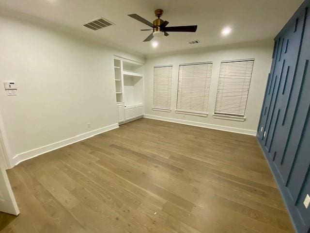 unfurnished bedroom featuring dark wood-type flooring and ceiling fan