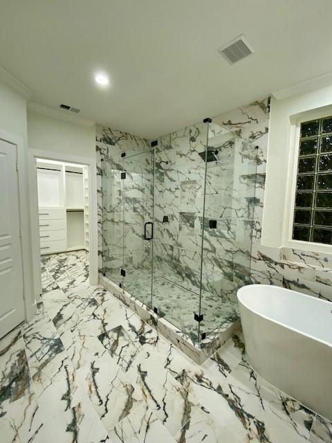 bathroom featuring separate shower and tub