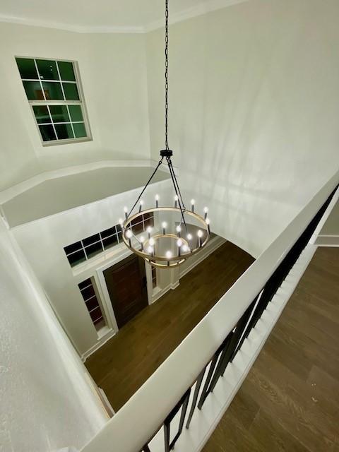 interior details with crown molding and a chandelier