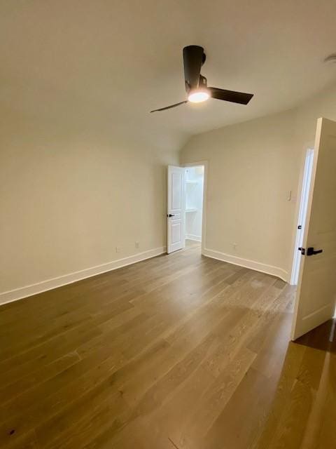 unfurnished room featuring ceiling fan, wood-type flooring, and vaulted ceiling