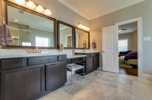 bathroom with crown molding, vanity, and a shower with shower door