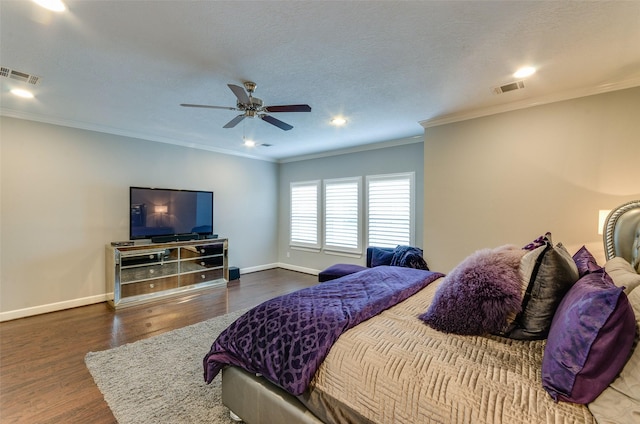 bedroom featuring ceiling fan, ornamental molding, dark hardwood / wood-style flooring, and a textured ceiling