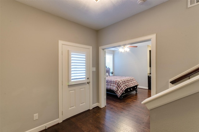 bedroom with dark hardwood / wood-style flooring