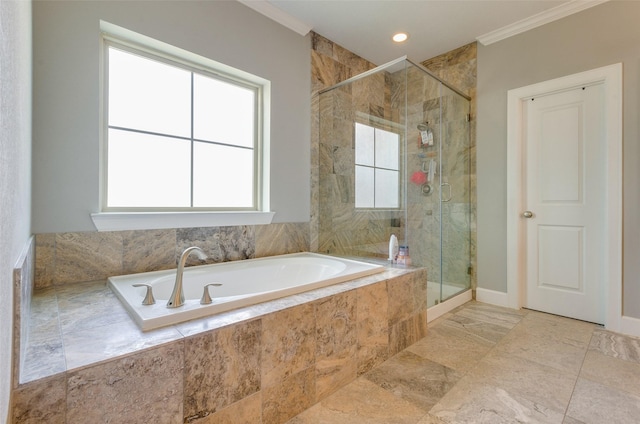 bathroom featuring ornamental molding and independent shower and bath