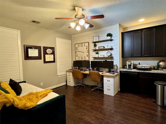 office space featuring dark hardwood / wood-style flooring, ceiling fan, and a textured ceiling