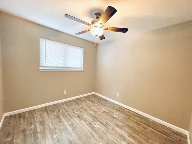 unfurnished room with hardwood / wood-style flooring and ceiling fan