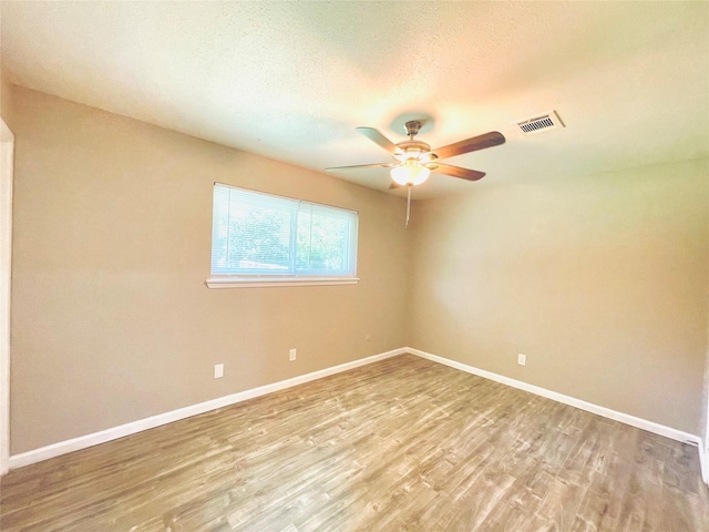 spare room with ceiling fan and light hardwood / wood-style floors